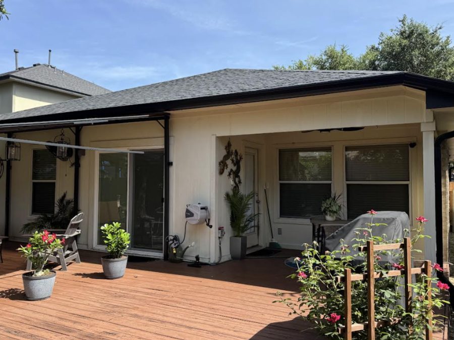 Back patio with black gutter system installed across the roof edge.